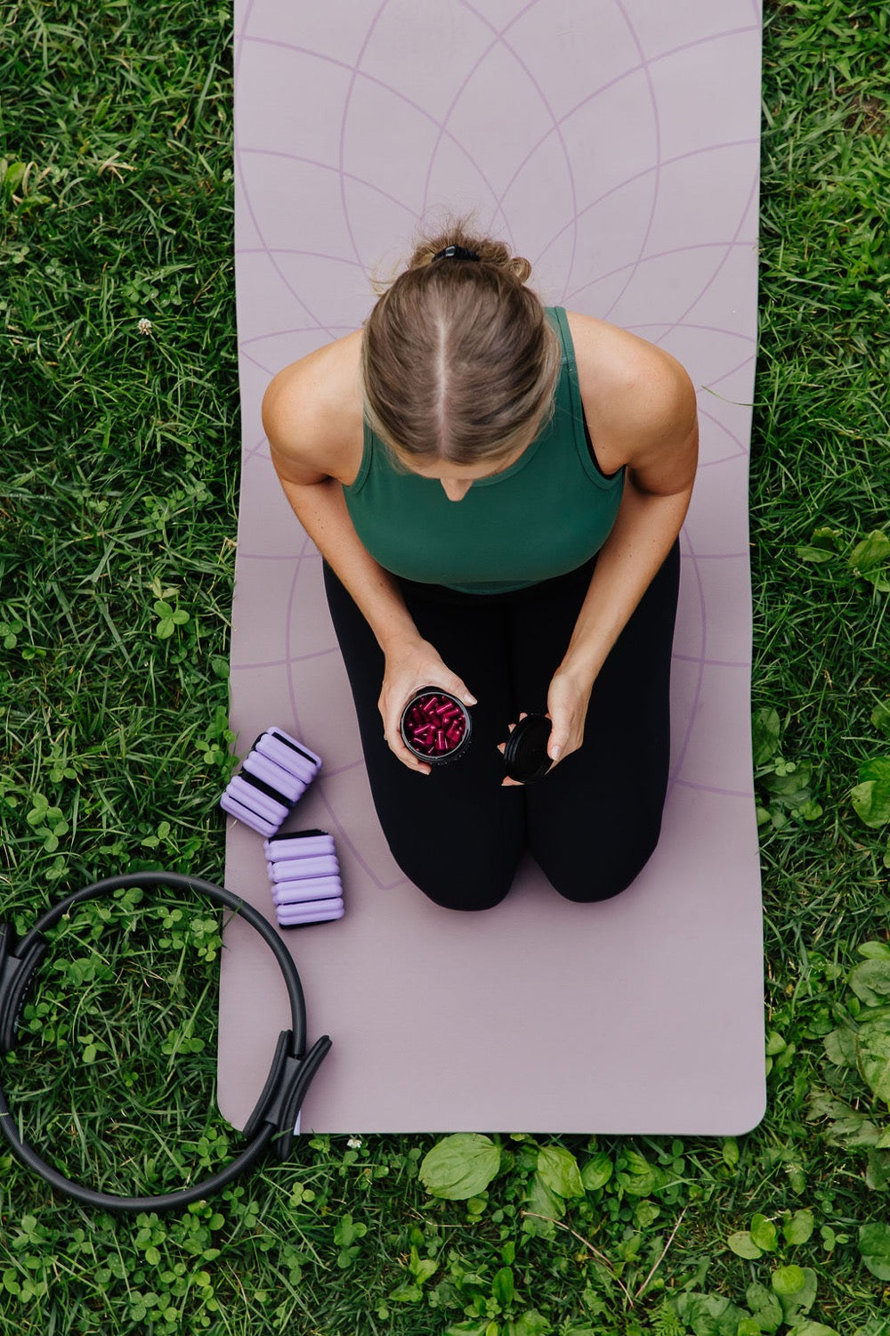 A woman outdoors on a yoga mat with Evolve